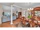 Elegant dining and living area featuring hardwood floors, a dining table, and a comfortable sofa at 1720 Ivey Trce, Cumming, GA 30041