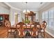 Elegant dining room featuring a decorative ceiling, chandelier, and wooden table set with carved chairs at 1720 Ivey Trce, Cumming, GA 30041