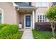 Inviting front door with a charming wreath, welcome sign, and neatly manicured shrubs at 1720 Ivey Trce, Cumming, GA 30041