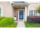 Welcoming front entrance featuring a charming blue door, decorative wreath, and inviting 'WELCOME' sign at 1720 Ivey Trce, Cumming, GA 30041