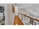 Hallway with hardwood floors, stair access, and neutral paint, leading to multiple rooms at 1720 Ivey Trce, Cumming, GA 30041