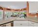 Bright kitchen with a granite countertop, stainless steel appliances, and a view to the backyard at 1720 Ivey Trce, Cumming, GA 30041