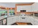 Bright kitchen with white cabinets, a granite countertop, a gas range stove, and stainless steel appliances at 1720 Ivey Trce, Cumming, GA 30041