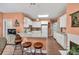 Bright kitchen featuring granite countertops, an island with seating, and stainless steel appliances at 1720 Ivey Trce, Cumming, GA 30041