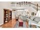 Open-concept living area with hardwood floors, staircase, and ample seating at 1720 Ivey Trce, Cumming, GA 30041