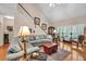 Well-lit living room with a sectional sofa, staircase, and hardwood flooring at 1720 Ivey Trce, Cumming, GA 30041