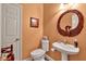 Stylish powder room with unique swan mirror and pedestal sink at 1720 Ivey Trce, Cumming, GA 30041