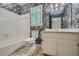 A full bathroom with white tub and vanity against floral wall paper at 2034 Starfire Ne Dr, Atlanta, GA 30345