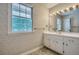 Bathroom with vintage patterned wallpaper, and traditional vanity with gold fixtures at 2034 Starfire Ne Dr, Atlanta, GA 30345