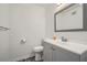 Updated half bathroom with gray vanity and new fixtures at 2034 Starfire Ne Dr, Atlanta, GA 30345