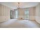 Bright dining room featuring decorative wallpaper, chair rail, and a chandelier at 2034 Starfire Ne Dr, Atlanta, GA 30345