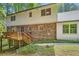 Back exterior of the home with brick and siding and deck at 2034 Starfire Ne Dr, Atlanta, GA 30345