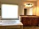 Bright bathroom featuring a soaking tub, granite countertop vanity, and large window at 3306 Chastain Ridge Dr, Marietta, GA 30066