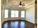 Bright bedroom featuring hardwood floors, a ceiling fan, and tray ceilings at 3306 Chastain Ridge Dr, Marietta, GA 30066