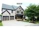 Beautiful two-story home with a manicured lawn and a two-car garage at 3306 Chastain Ridge Dr, Marietta, GA 30066