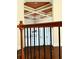 Foyer featuring hardwood floors, wrought iron railing, and tray ceiling at 3306 Chastain Ridge Dr, Marietta, GA 30066