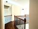 Hallway featuring hardwood floors, wrought iron railing, and ceiling with tray ceiling at 3306 Chastain Ridge Dr, Marietta, GA 30066