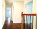 Hallway featuring hardwood floors, wrought iron railing, and arched doorways at 3306 Chastain Ridge Dr, Marietta, GA 30066