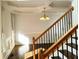 Elegant staircase with hardwood treads and decorative iron railing adjacent to dining room at 3306 Chastain Ridge Dr, Marietta, GA 30066