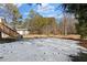 Snowy backyard with trees and shed in the background at 4064 Post Rd, Winston, GA 30187