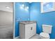 Bright bathroom featuring blue accent walls, granite countertop vanity and bright lighting at 4064 Post Rd, Winston, GA 30187