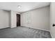 Bedroom features gray carpet and neutral paint, with dark door leading to the hallway at 4064 Post Rd, Winston, GA 30187