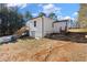 Exterior of the home showing the basement level and deck with staircases on a partially wooded lot at 4064 Post Rd, Winston, GA 30187