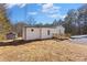 Charming home featuring a deck and wheelchair ramp, set amongst mature trees in a private setting at 4064 Post Rd, Winston, GA 30187