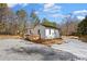 Charming home boasts a newly installed wooden deck and beautiful wooded surroundings at 4064 Post Rd, Winston, GA 30187