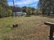 View of the home featuring mature trees, a covered entry, and a spacious grass front yard at 4064 Post Rd, Winston, GA 30187