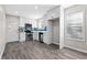 Stylish eat-in kitchen featuring stainless steel appliances, white cabinets, luxury vinyl plank flooring, and tiled backsplash at 4064 Post Rd, Winston, GA 30187