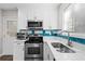 Modern kitchen featuring stainless steel appliances, white countertops, and trendy backsplash at 4064 Post Rd, Winston, GA 30187