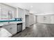 Bright open kitchen with white cabinets, stainless appliances, and gray wood flooring at 4064 Post Rd, Winston, GA 30187