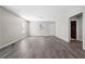 Bright living room with gray flooring, leading to front door and bedroom hallway at 4064 Post Rd, Winston, GA 30187