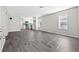 Spacious living room features modern gray wood flooring, neutral paint, and bright windows at 4064 Post Rd, Winston, GA 30187