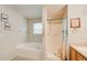 Bathroom featuring a soaking tub, and a walk-in shower with a decorative shower curtain at 10892 Big Sky Dr, Hampton, GA 30228