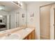 Neutral bathroom featuring dual sinks, a large mirror, and a doorway to the bedroom at 10892 Big Sky Dr, Hampton, GA 30228