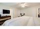 Neutral bedroom featuring a ceiling fan, dresser, and a weightlifting bench at 10892 Big Sky Dr, Hampton, GA 30228