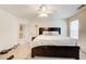 Spacious bedroom with a ceiling fan, large bed, and doorway leading to another room at 10892 Big Sky Dr, Hampton, GA 30228