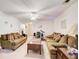 Spacious living room with comfortable couches and lots of natural light from overhead fan and multiple fixtures at 10892 Big Sky Dr, Hampton, GA 30228