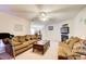 Open living room featuring dual couches, fireplace, and view to dining area at 10892 Big Sky Dr, Hampton, GA 30228