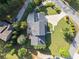 An aerial view captures the house's manicured lawn, landscaping, backyard with seating and deck, and adjacent neighborhood street at 1435 Willis Lake Nw Dr, Kennesaw, GA 30152