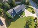 Overhead view of the property shows the spacious manicured lawn, and the roof, surrounded by mature trees and lush greenery at 1435 Willis Lake Nw Dr, Kennesaw, GA 30152