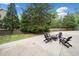 Backyard patio featuring an outdoor seating area with Adirondack chairs, fire pit, landscaping and privacy fence at 1435 Willis Lake Nw Dr, Kennesaw, GA 30152