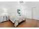 Bedroom featuring hardwood floors, built in closets, and a comfortable bed at 1435 Willis Lake Nw Dr, Kennesaw, GA 30152