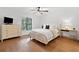 Bright bedroom featuring hardwood floors, a ceiling fan, and natural light from a window at 1435 Willis Lake Nw Dr, Kennesaw, GA 30152