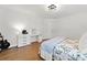 Bright bedroom features white walls, wood floors, and a floral comforter, creating a cozy and inviting space at 1435 Willis Lake Nw Dr, Kennesaw, GA 30152