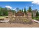 Elegant stone entrance sign to Sentinel Walk, enhanced by colorful flowers and lush landscaping at 1435 Willis Lake Nw Dr, Kennesaw, GA 30152