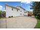 Wide driveway and backyard view of the home, with an exterior of white siding and garage entry at 1435 Willis Lake Nw Dr, Kennesaw, GA 30152