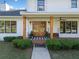 Charming front entrance with wood columns, double glass doors, and manicured landscaping at 1435 Willis Lake Nw Dr, Kennesaw, GA 30152